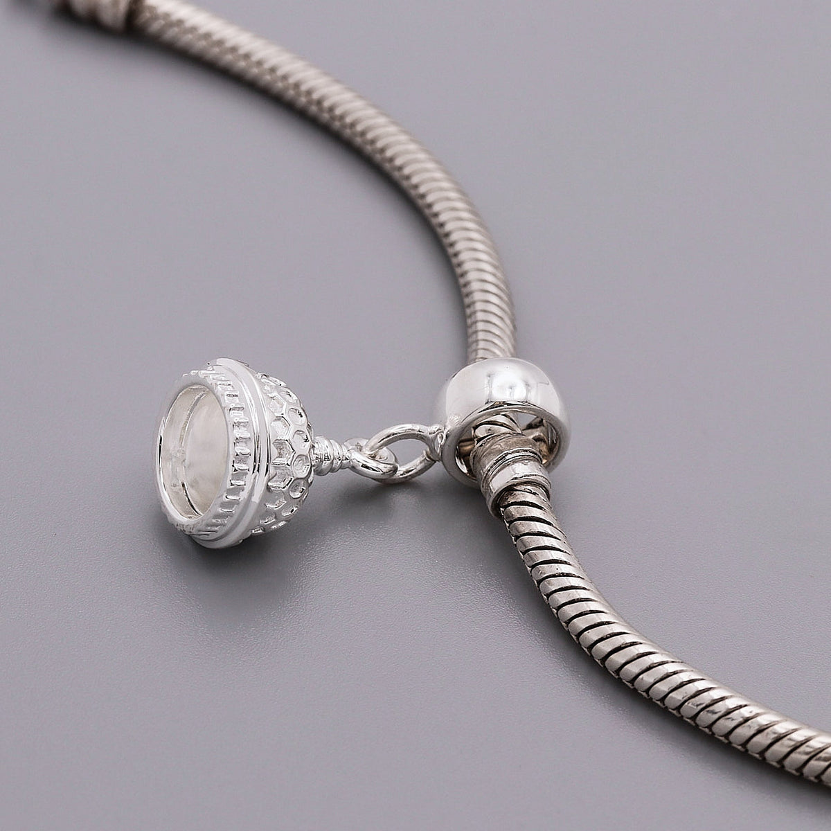 Silver charm shaped like the Brighton Pavilion, detailed and polished, displayed on a white background by Scarlett Jewellery.