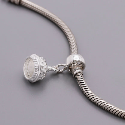 Silver charm shaped like the Brighton Pavilion, detailed and polished, displayed on a white background by Scarlett Jewellery.