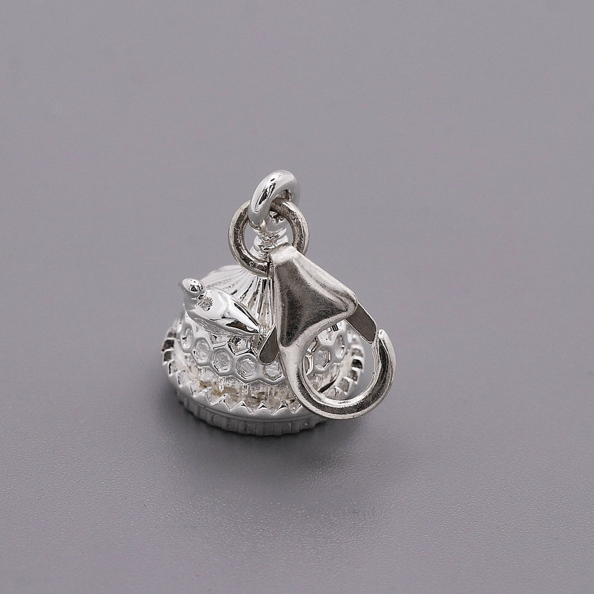 Silver charm shaped like the Brighton Pavilion, detailed and polished, displayed on a white background by Scarlett Jewellery.