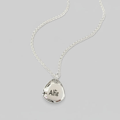 Silver pet paw print charm with personalized engraving by Scarlett Jewellery.