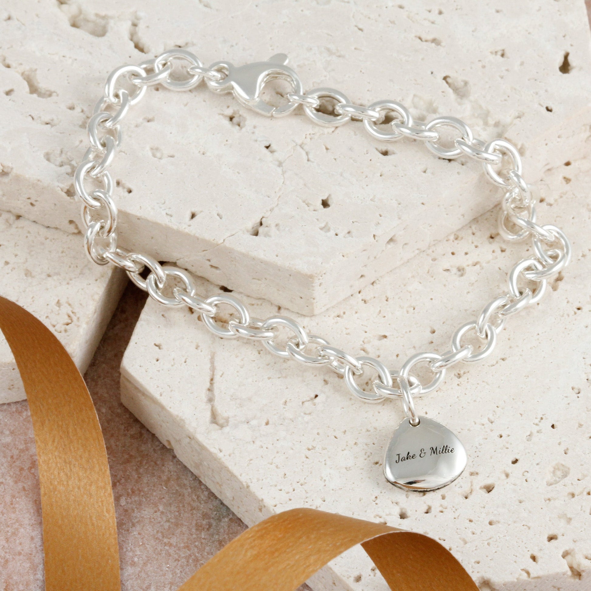 Silver paw print charm with personalized engraving, part of the Scarlett Jewellery charm collection.