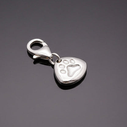 Silver paw print charm with personalized engraving, part of the Pet Charms collection by Scarlett Jewellery.
