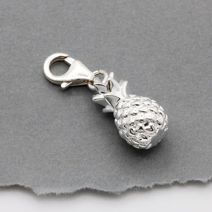 Silver pineapple charm with detailed texture, shown against a white background, by Scarlett Jewellery.