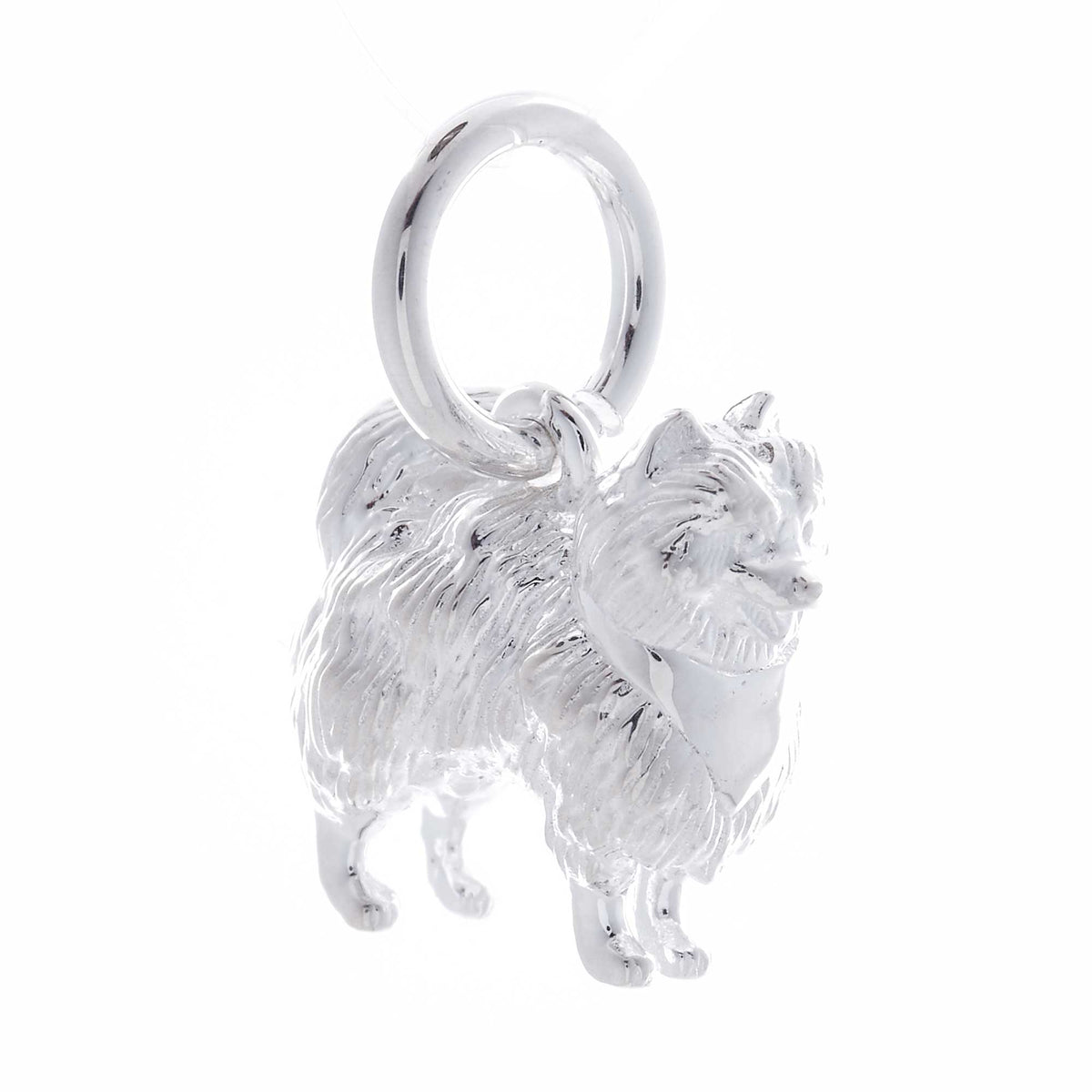 A silver Pomeranian dog charm shaped like a tiny puppy, detailed with smooth lines and a polished finish, by Scarlett Jewelle