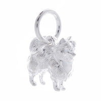 A silver Pomeranian dog charm shaped like a tiny puppy, detailed with smooth lines and a polished finish, by Scarlett Jewelle