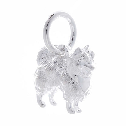 A silver Pomeranian dog charm shaped like a tiny puppy, detailed with smooth lines and a polished finish, by Scarlett Jewelle