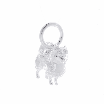 A silver Pomeranian dog charm shaped like a tiny puppy, detailed with realistic features, by Scarlett Jewellery.