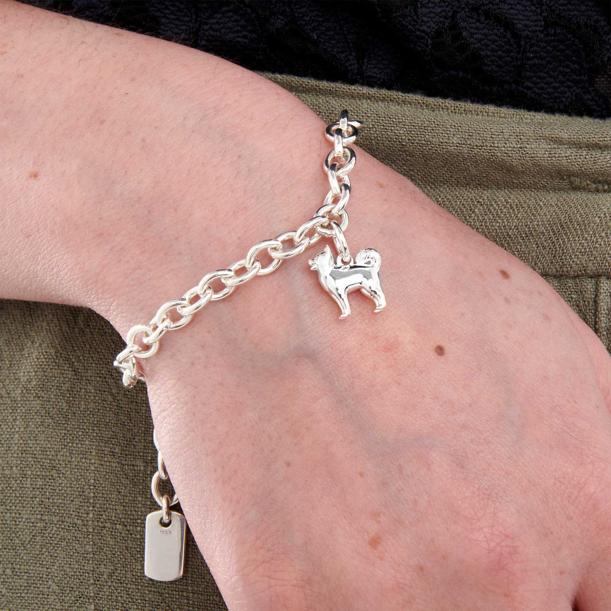 Silver dog charm bracelet featuring a Pomsky design by Scarlett Jewellery.
