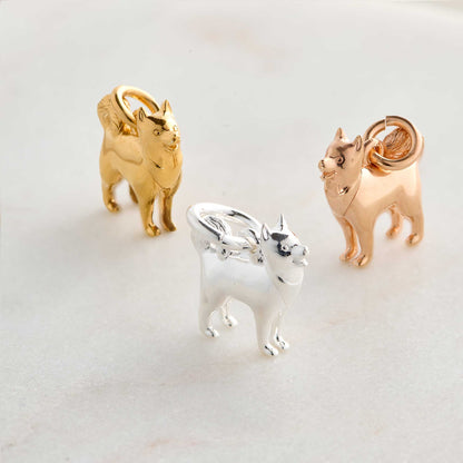 A silver pomsky dog charm hangs from a chain, detailed with realistic fur texture and expressive eyes by Scarlett Jewellery.