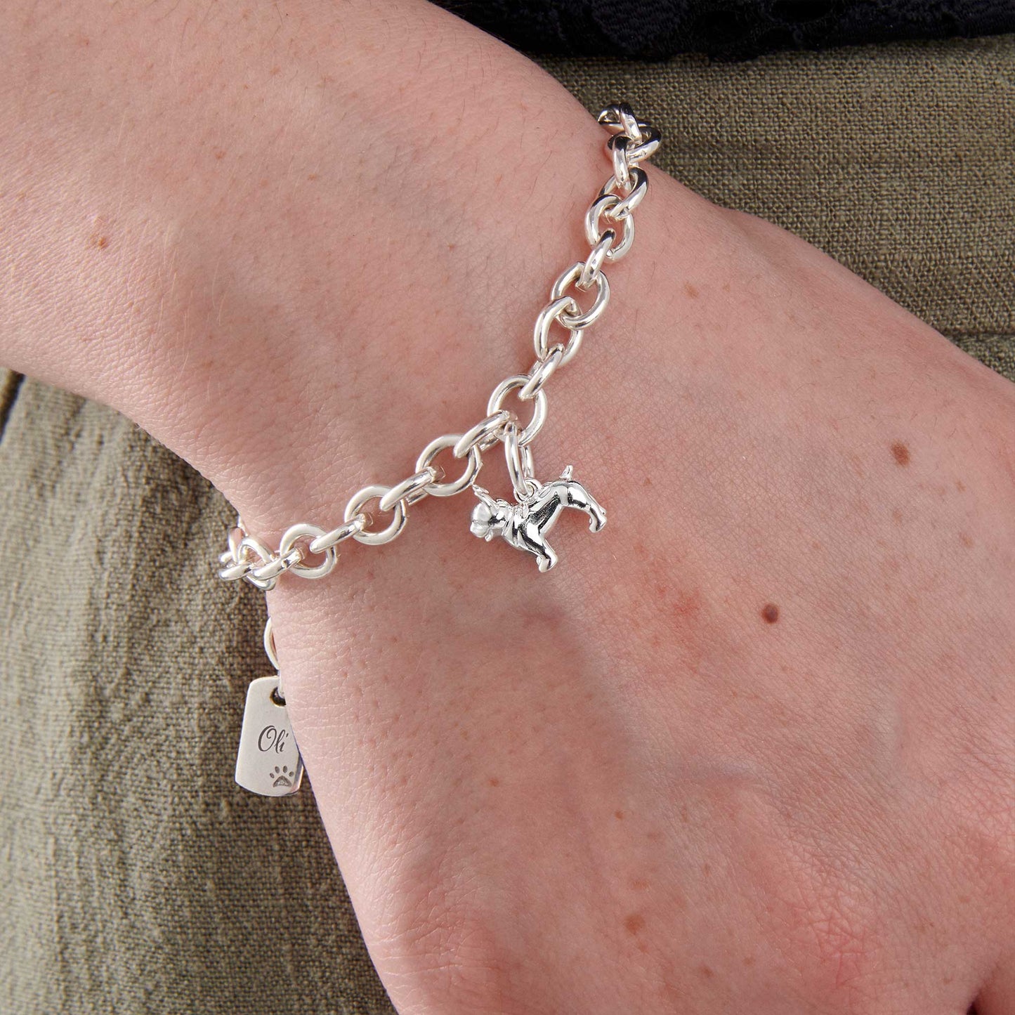 A silver pug dog charm bracelet by Scarlett Jewellery with a detailed paw print and chain design