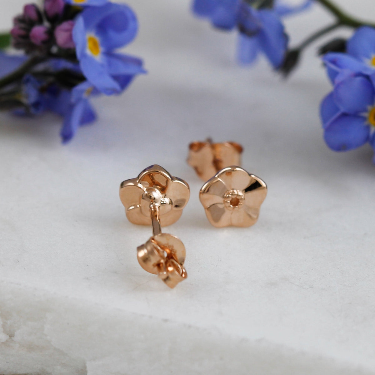 Tiny rose gold vermeil stud earrings with a delicate forget-me-not design by Scarlett Jewellery.