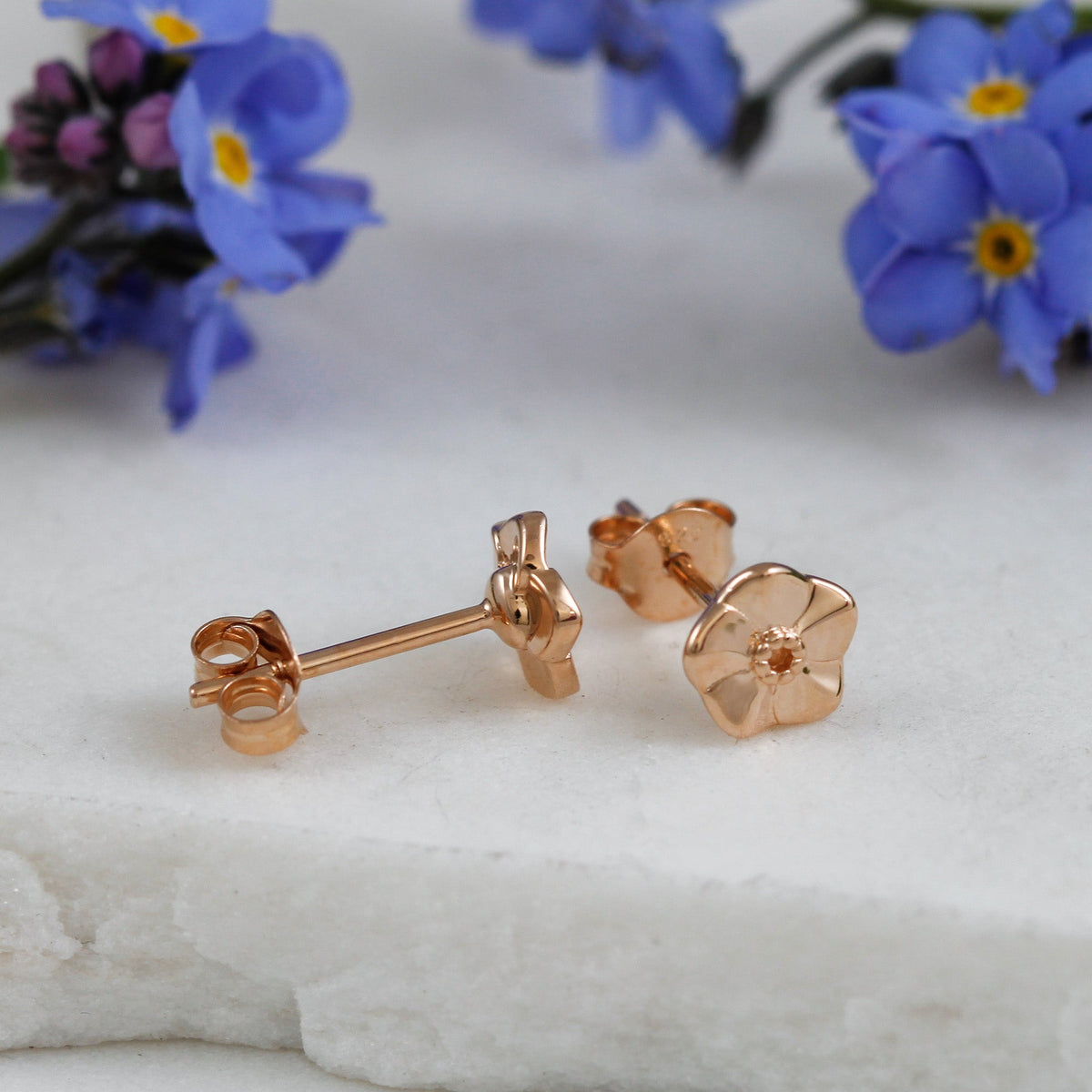 Tiny rose gold vermeil stud earrings with a forget-me-not design by Scarlett Jewellery