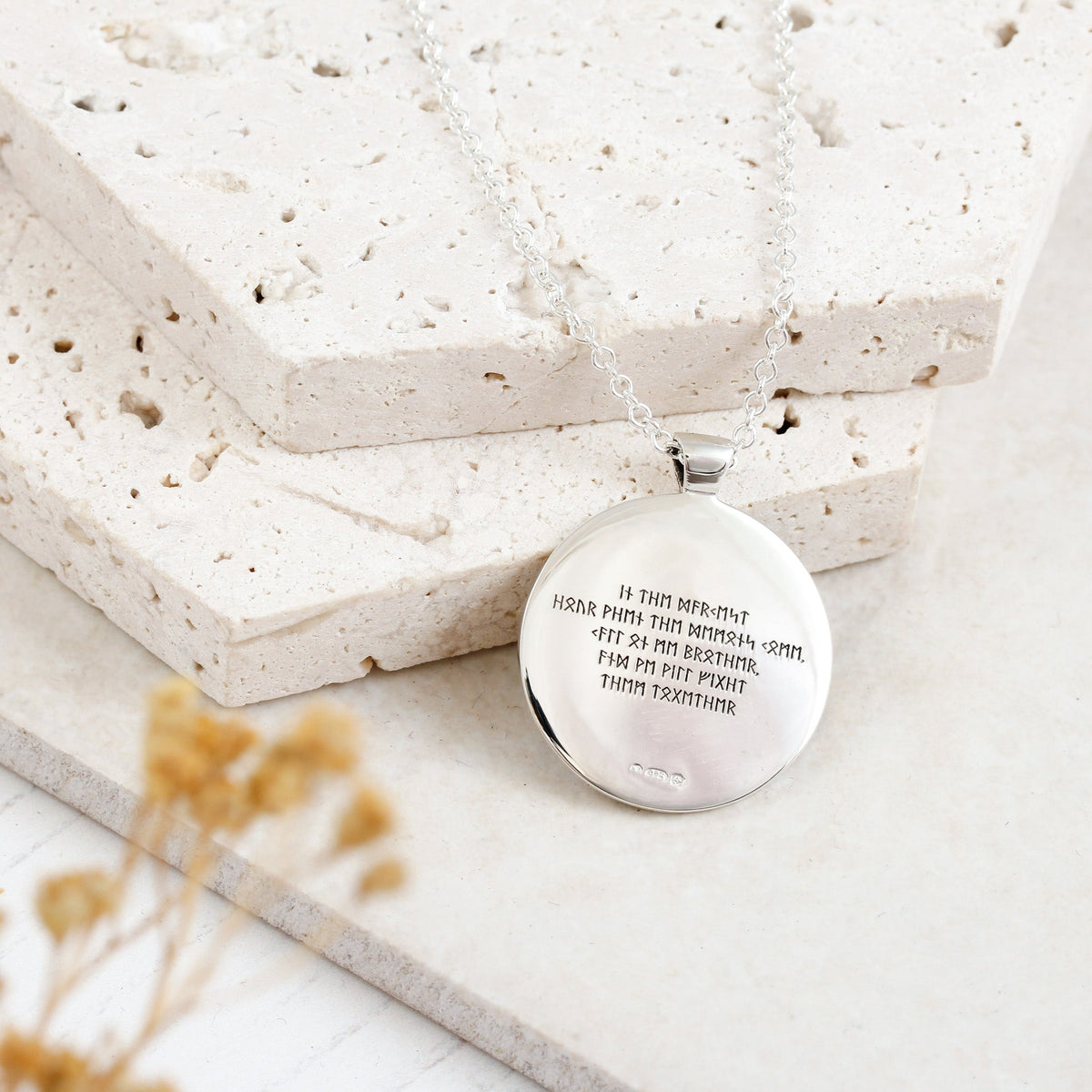 Silver Viking rune necklace with personalized engraving, featuring a small pendant on a chain, by Scarlett Jewellery.
