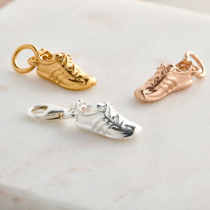 Silver charm with a running shoe design on a white background by Scarlett Jewellery.