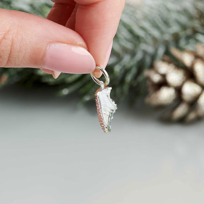 Silver charm with detailed etching on a running shoe by Scarlett Jewellery.