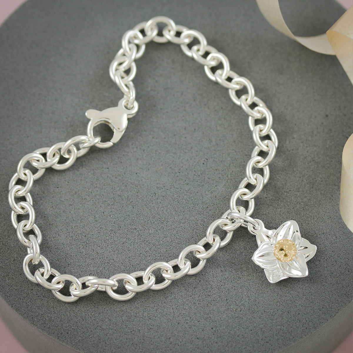 A daffodil flower charm in silver and solid gold by Scarlett Jewellery