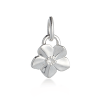 A silver forget-me-not flower charm with delicate petals, personalized engraving, and a polished finish by Scarlett Jewellery