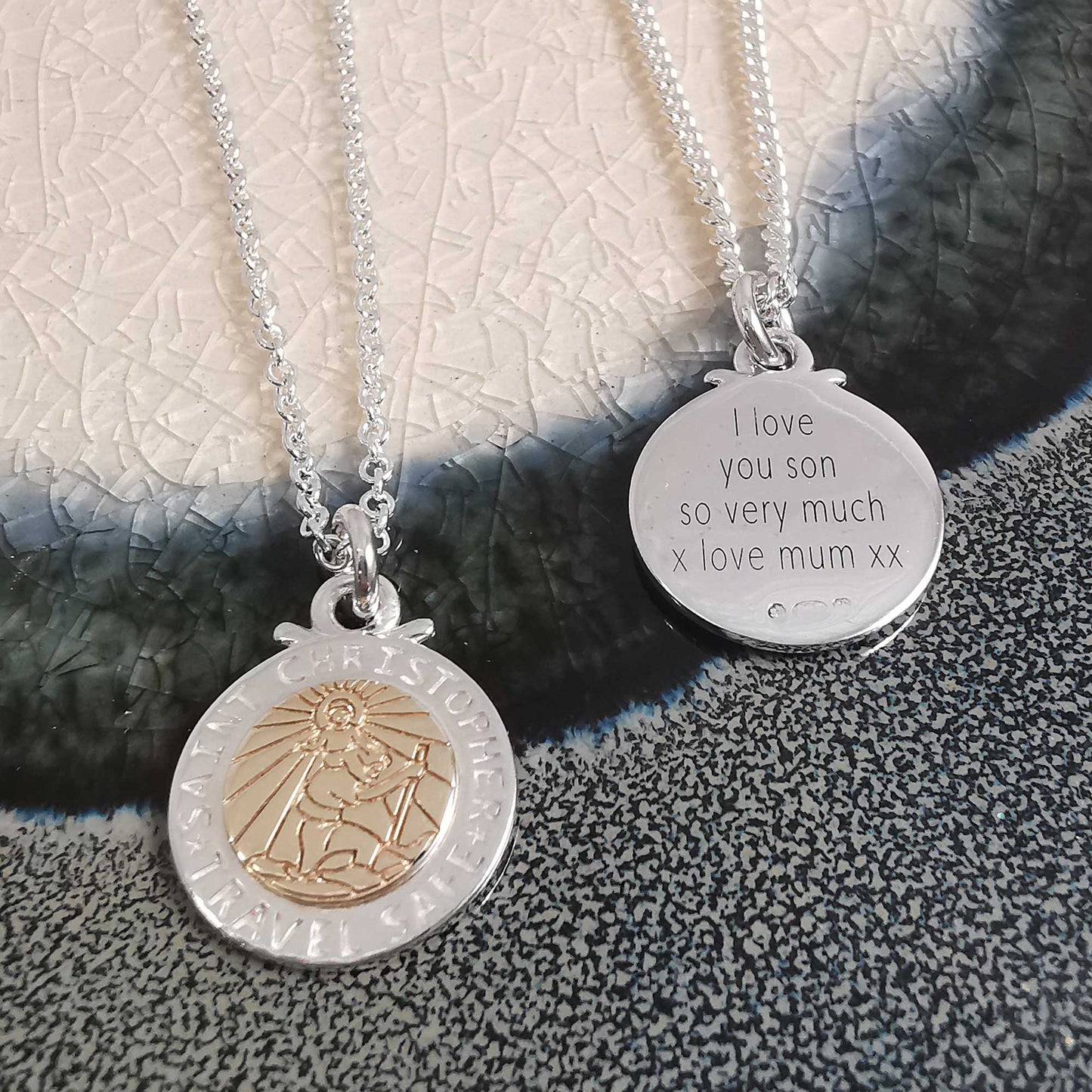 A silver and rose gold St Christopher necklace with personalized engraving, displayed on a soft background by Scarlett Jewell