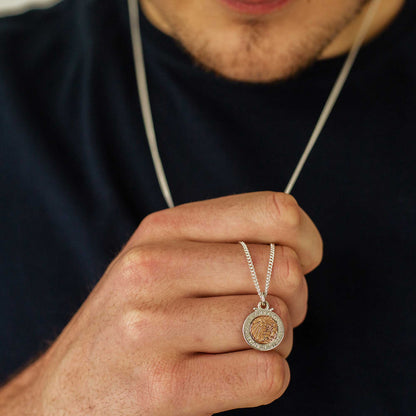 A silver and rose gold St Christopher necklace with personalized engraving, displayed on a soft background by Scarlett Jewell