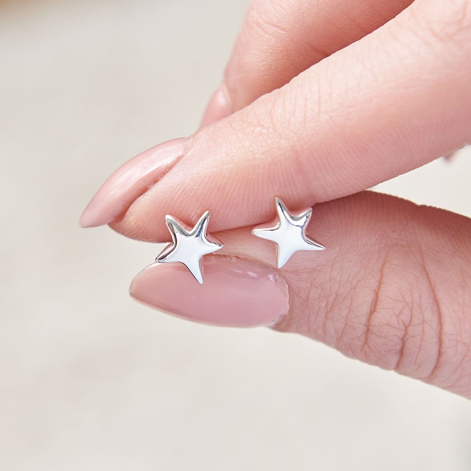 Sterling silver stud earrings with a shimmering starry finish, featuring tiny sparkles, by Scarlett Jewellery.