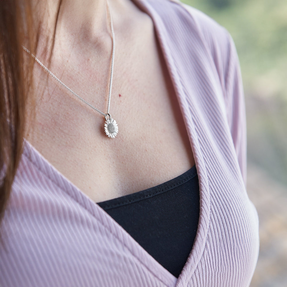 Sunflower silver charm with detailed petal texture, displayed on a soft white background by Scarlett Jewellery.