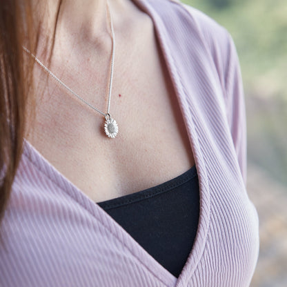 Sunflower silver charm with detailed petal texture, displayed on a soft white background by Scarlett Jewellery.