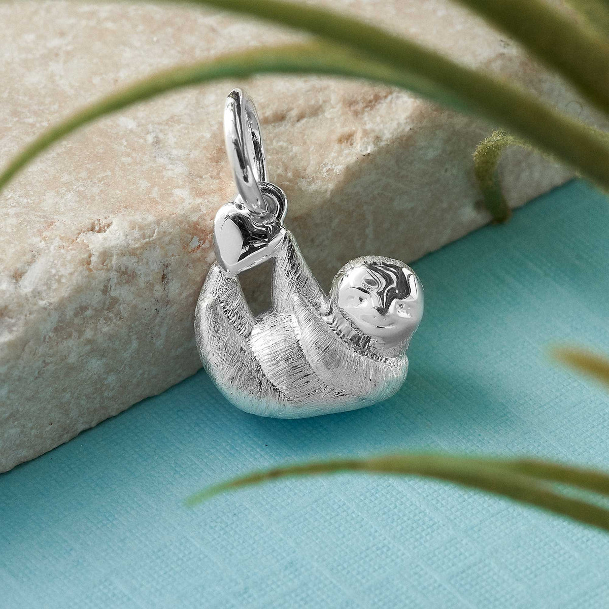 Sloth silver charm in a close-up shot, detailed with intricate design, by Scarlett Jewellery.