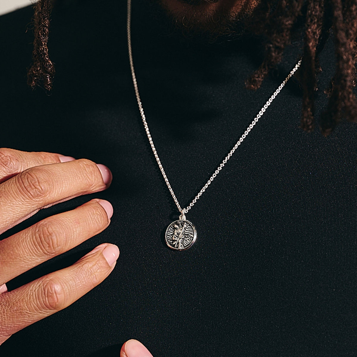 A small silver St Christopher necklace with a detailed cross design by Scarlett Jewellery