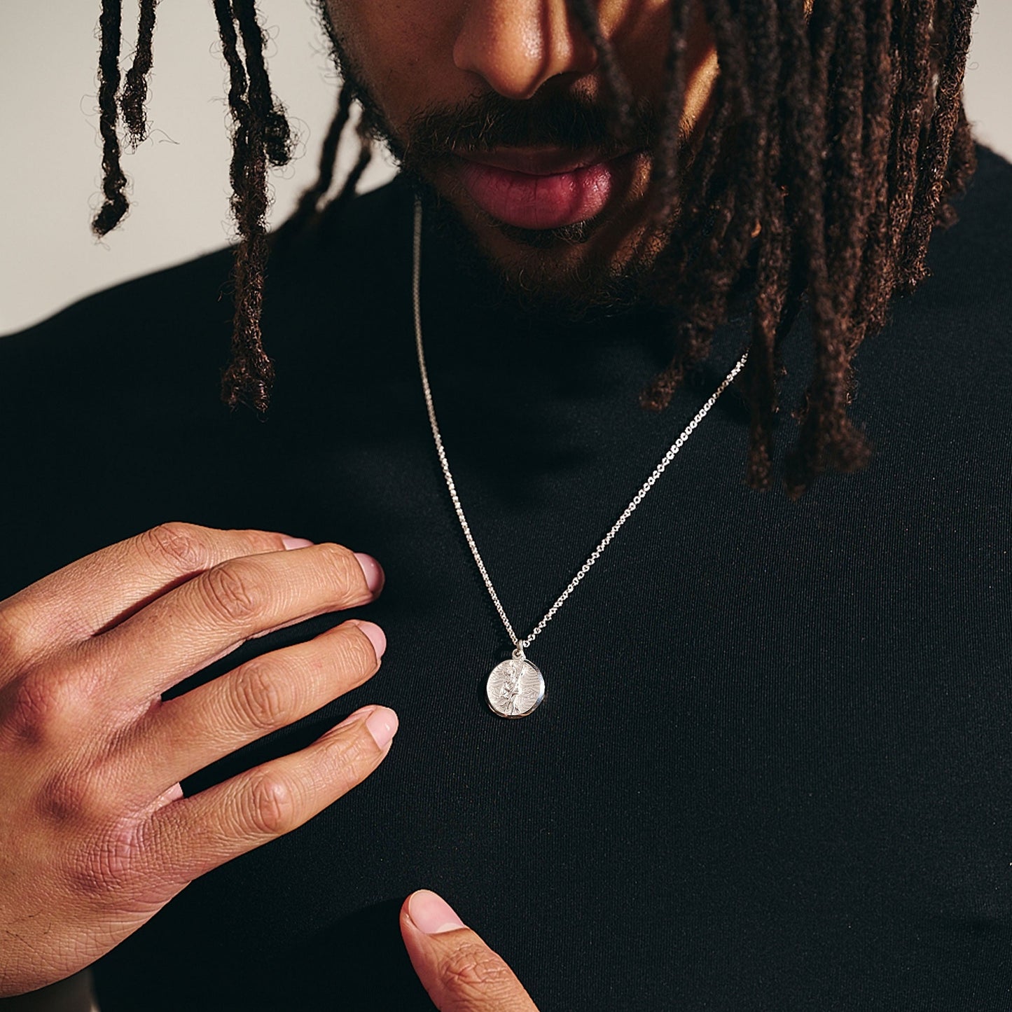Small silver St Christopher necklace with detailed chain and cross design by Scarlett Jewellery