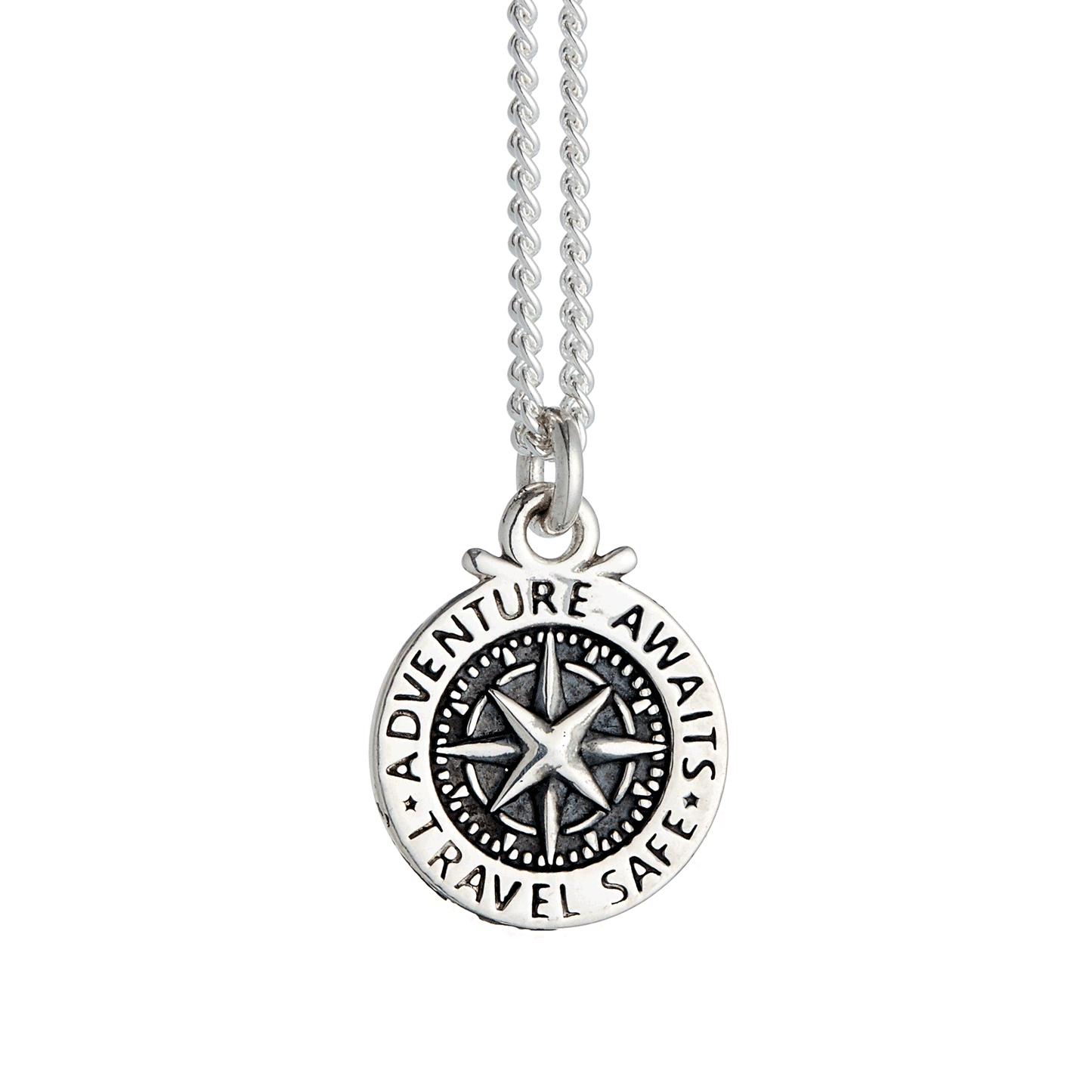 A silver compass charm with engraved details, displayed on a soft background, part of the Travel Safe collection by Scarlett 