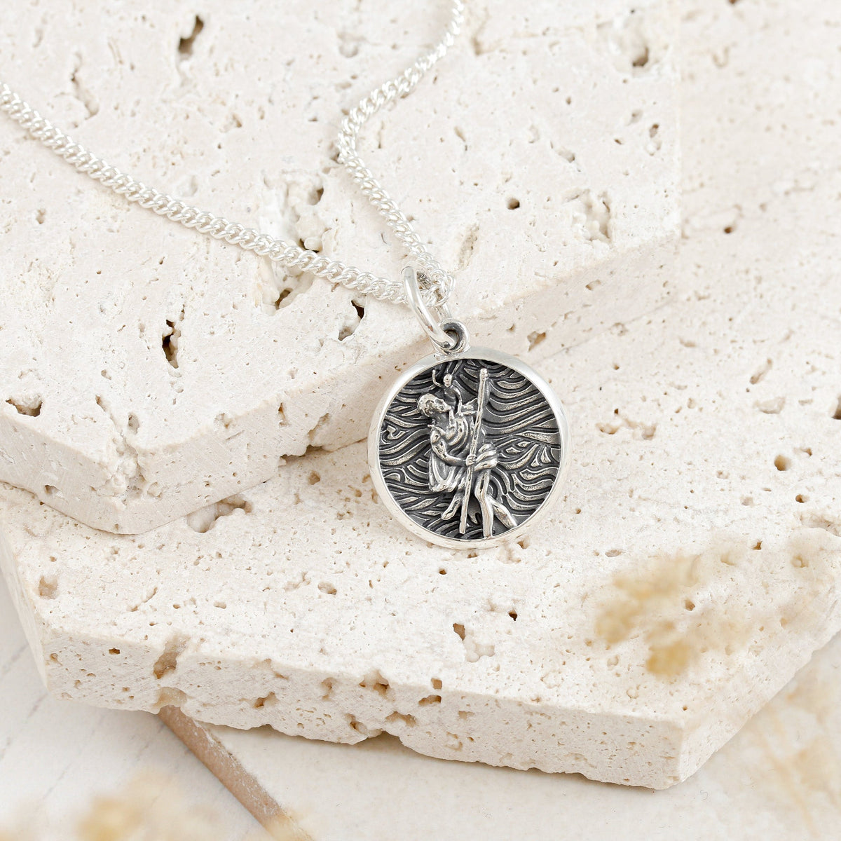 A small silver St Christopher necklace with a detailed cross design by Scarlett Jewellery