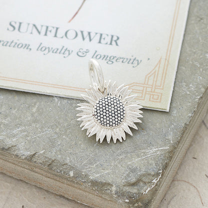 Sunflower silver charm with intricate details on a white background by Scarlett Jewellery.