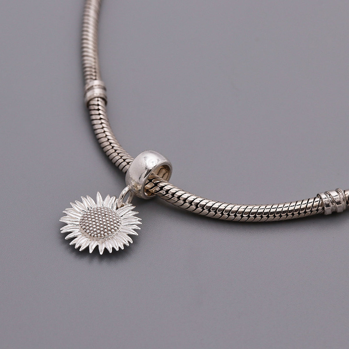 Sunflower silver charm with detailed petal texture by Scarlett Jewellery.
