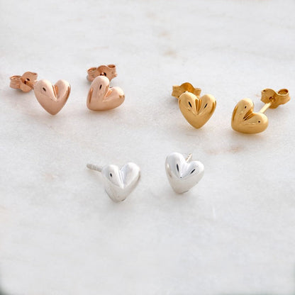Sweetheart silver stud earrings with delicate heart design by Scarlett Jewellery.