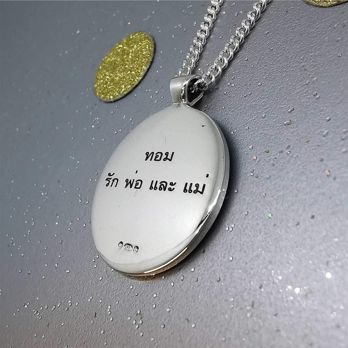 Silver Viking rune necklace with personalized engraving, featuring a small pendant on a chain, by Scarlett Jewellery.