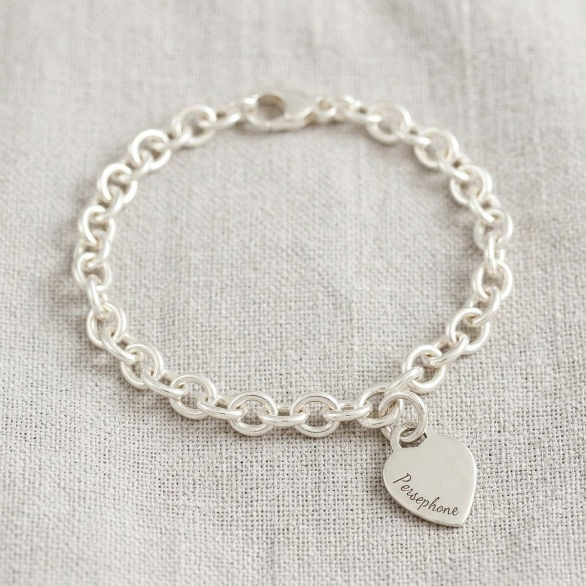 A silver heart tag charm bracelet with personalized engraving by Scarlett Jewellery
