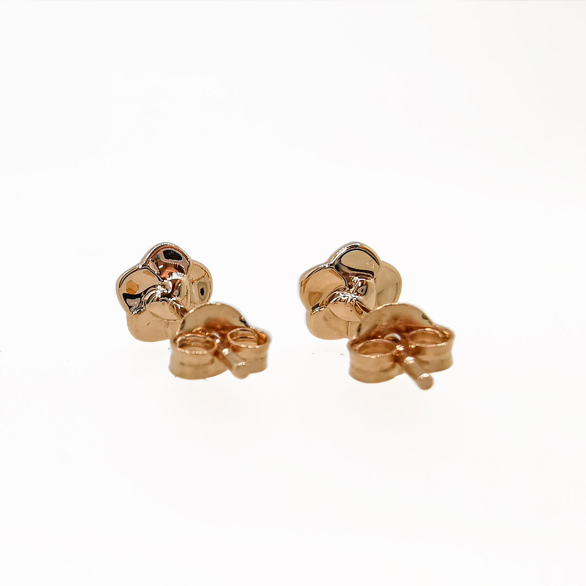 Tiny rose gold vermeil stud earrings with a forget-me-not design by Scarlett Jewellery