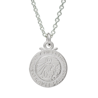 Silver St Christopher pendant on a chain with personalized engraving, styled on a wooden table.