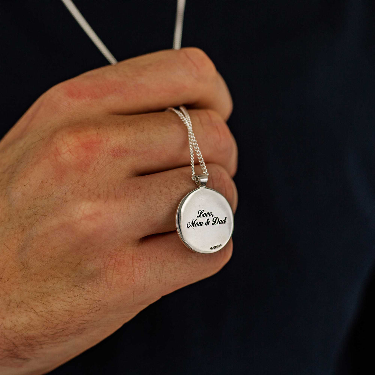 Silver Viking rune necklace with personalized engraving, featuring a small pendant on a chain, by Scarlett Jewellery.