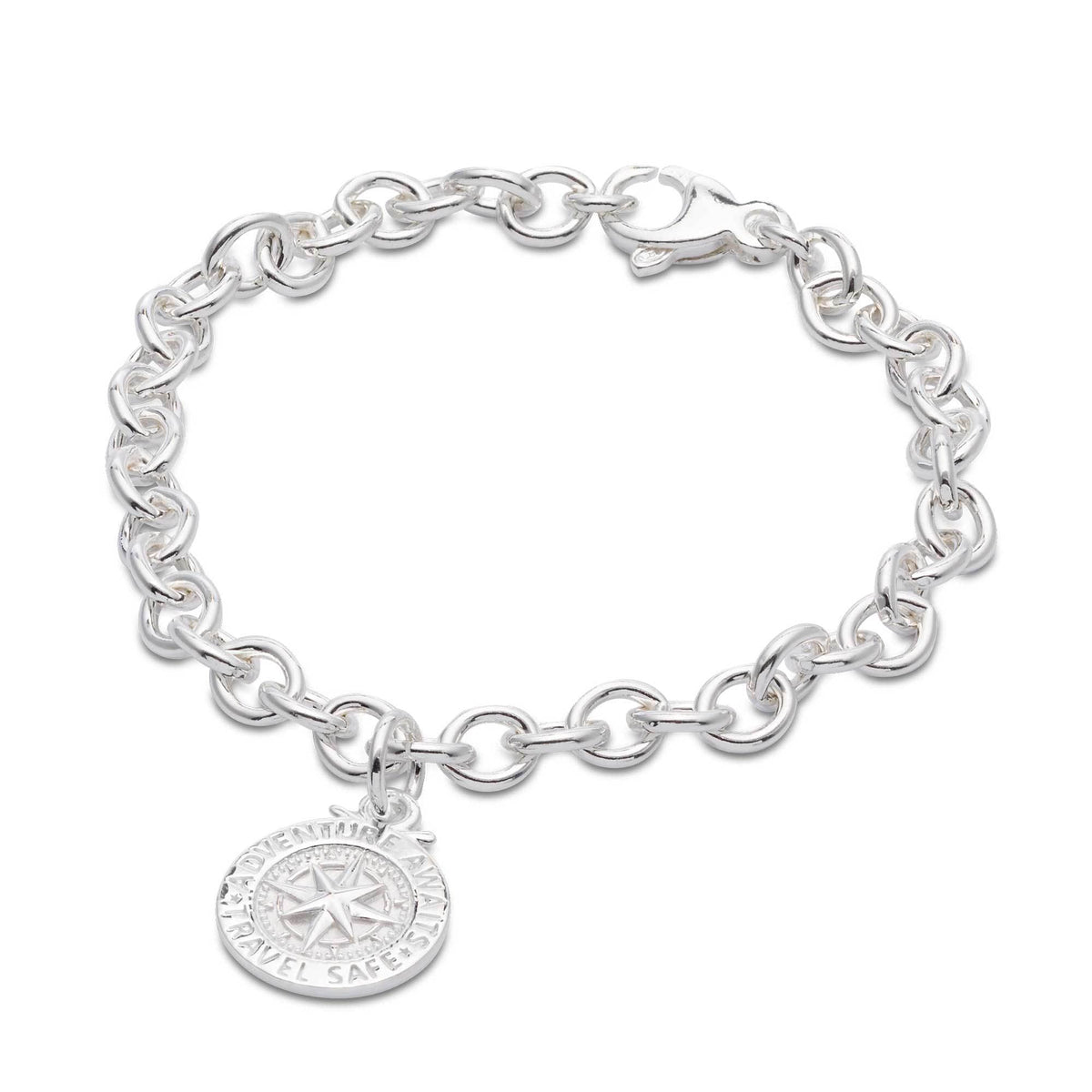 Silver compass charm with personalized engraving, styled on a travel-themed background by Scarlett Jewellery.