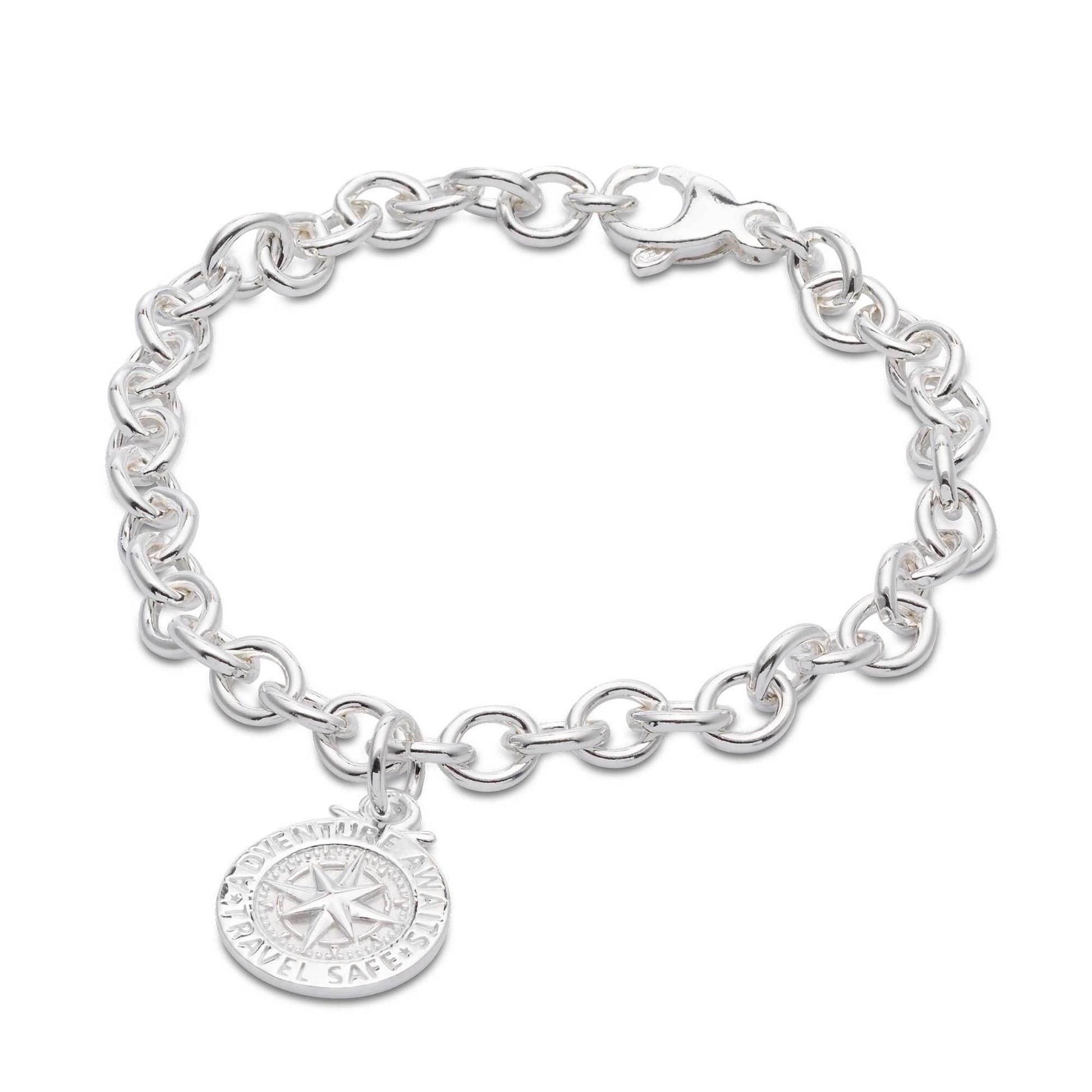 Silver compass charm with personalized engraving, styled on a travel-themed background by Scarlett Jewellery.