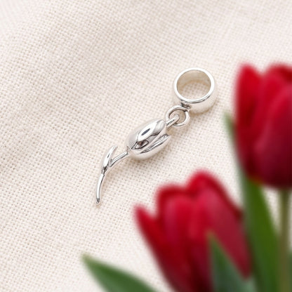 A silver tulip flower charm with intricate detailing, displayed on a soft white background, by Scarlett Jewellery.