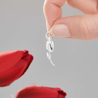 A silver tulip flower charm with intricate detailing, displayed on a soft white background, by Scarlett Jewellery.