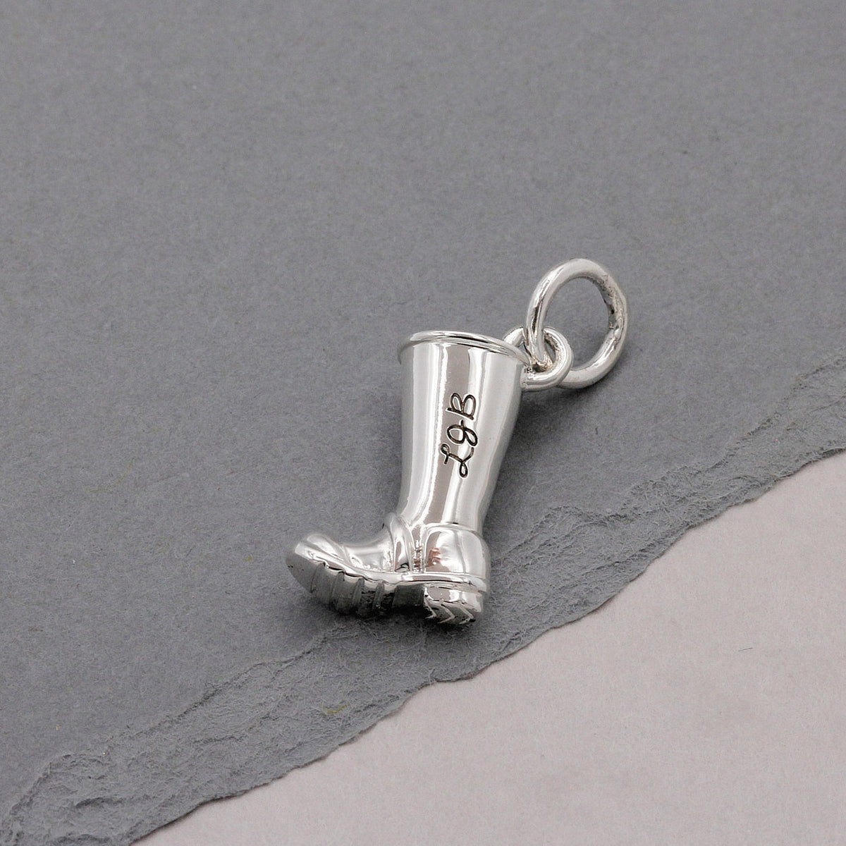 Silver charm with personalized engraving on a welly boot by Scarlett Jewellery.