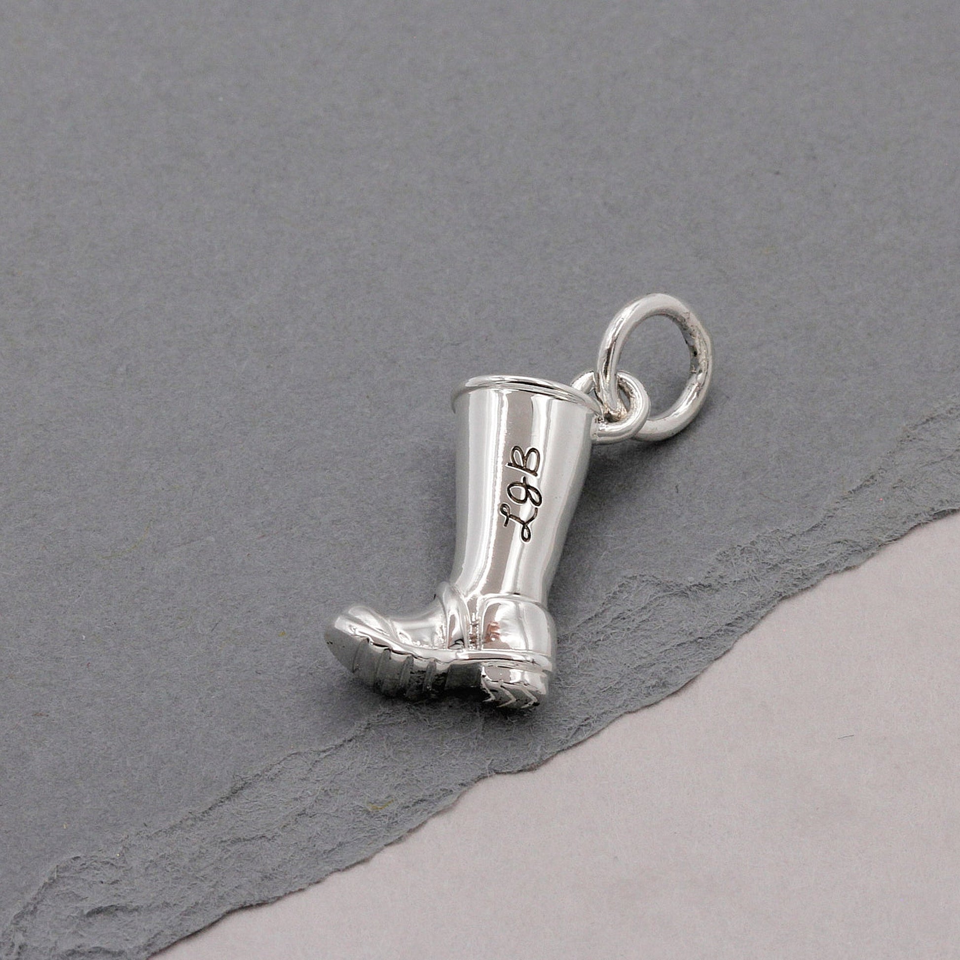 Silver charm with personalized engraving on a welly boot by Scarlett Jewellery.