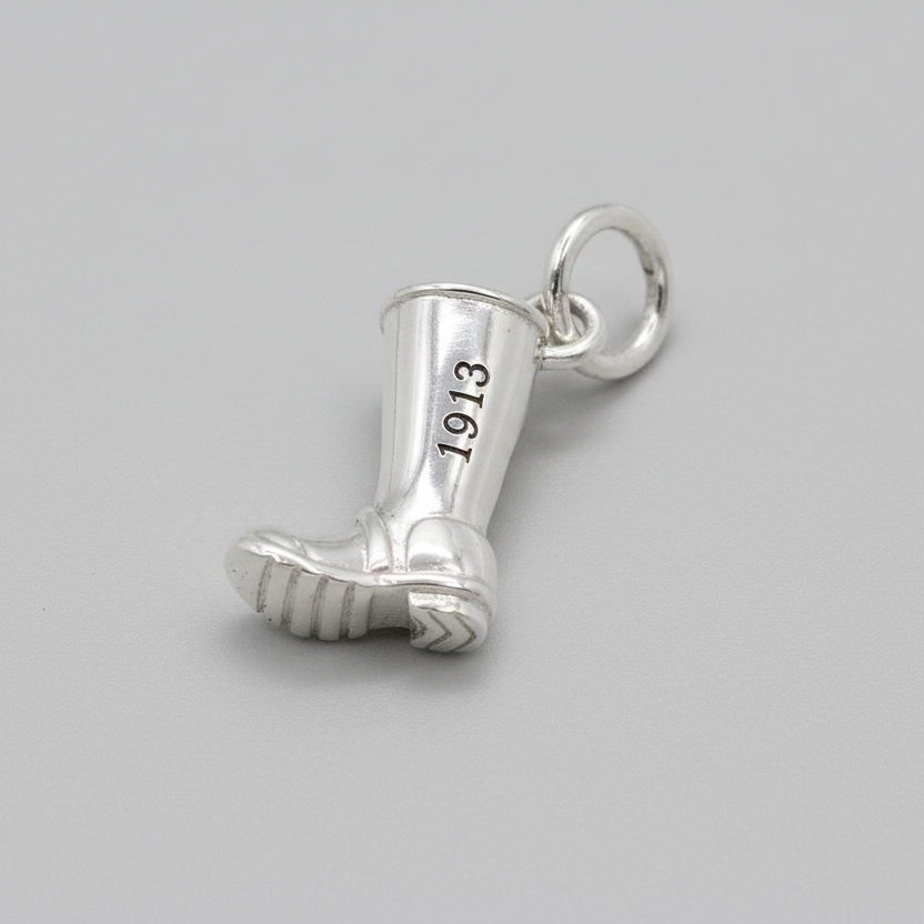 Silver charm with personalized engraving on a welly boot by Scarlett Jewellery.