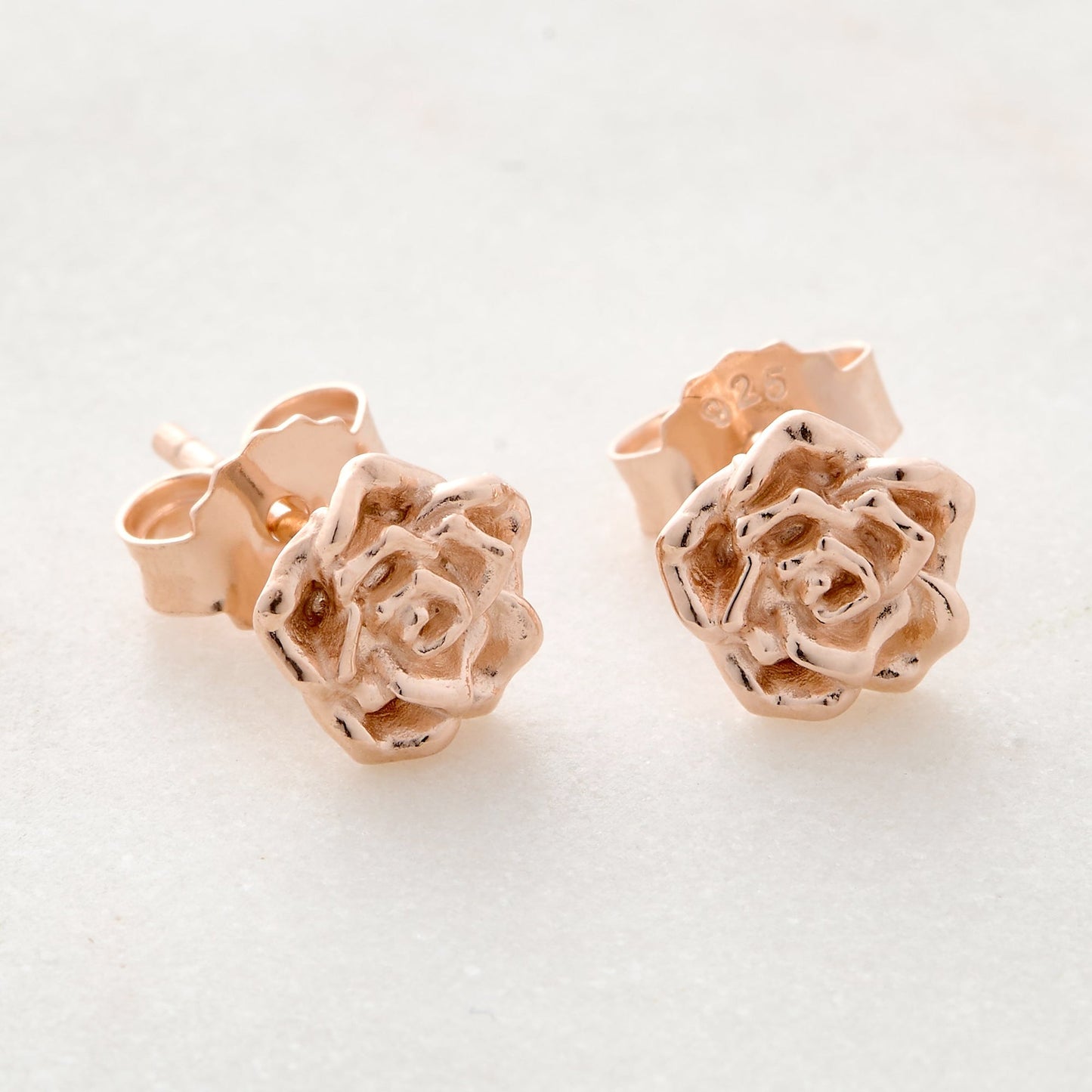 Wild rose gold vermeil silver stud earrings with delicate floral details by Scarlett Jewellery.