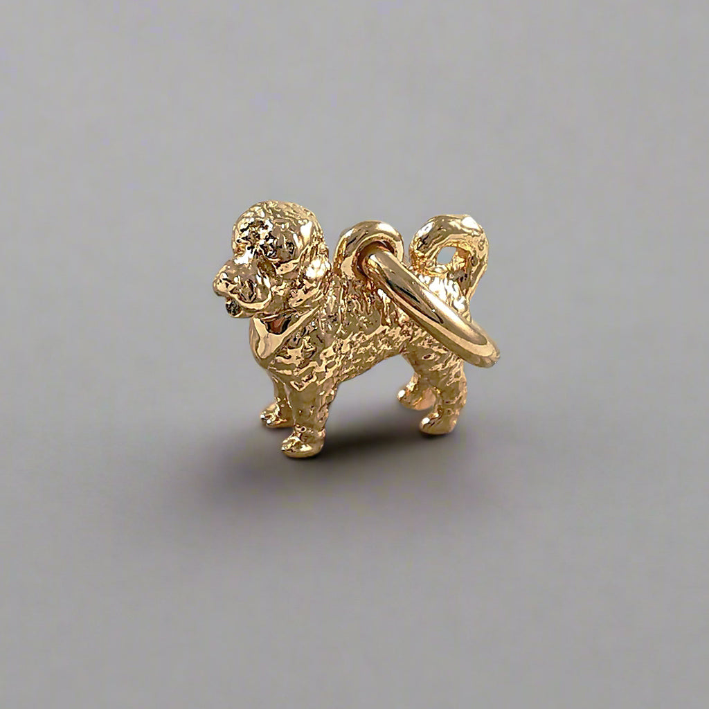 Silver dog charm shaped like a cavapoo, detailed with realistic features, by Scarlett Jewellery.