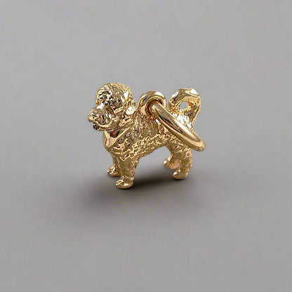 Silver dog charm shaped like a cavapoo, detailed with realistic features, by Scarlett Jewellery.