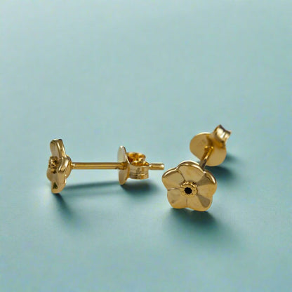 Tiny gold vermeil stud earrings with a delicate forget-me-not design by Scarlett Jewellery